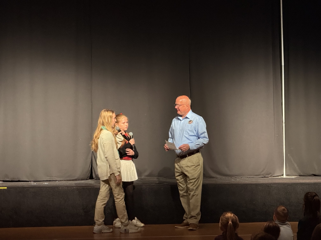 Mr. John being introduced by students