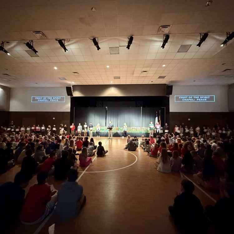 fruit of the spirit award recipients standing at the front of chapel holding up their awards