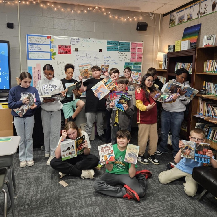 5th graders showing off their books