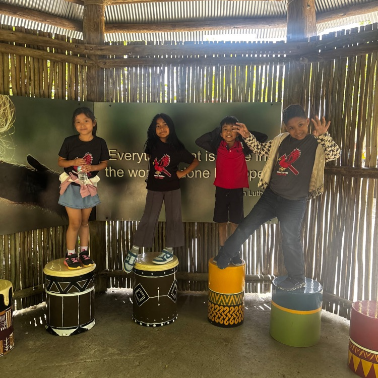 Second grade students playing on drums