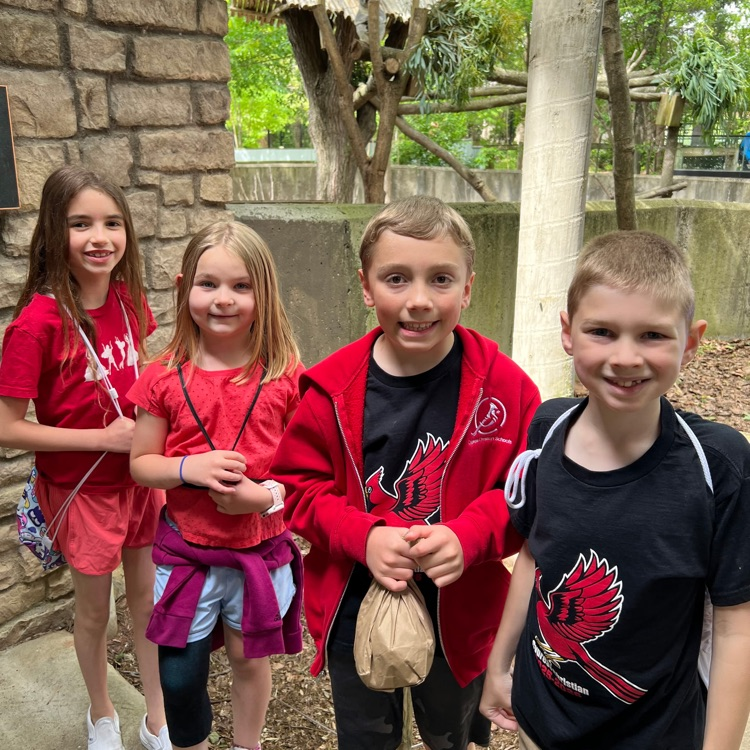 fourth grade student standing and smiling at the zoo