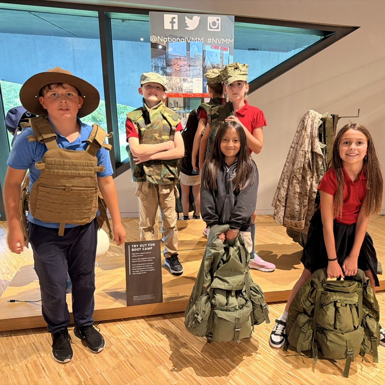 several fifth grade students in gear trying out for boot camp