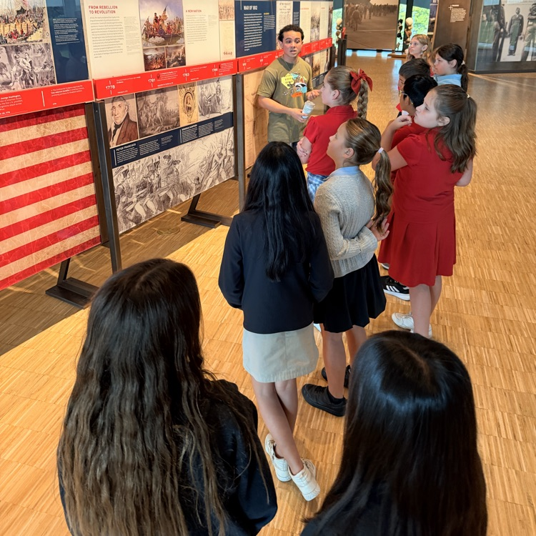 group of 5th grade students listening to information about wars