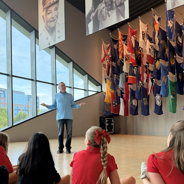 students listening to a talk at the veterans memorial and museum