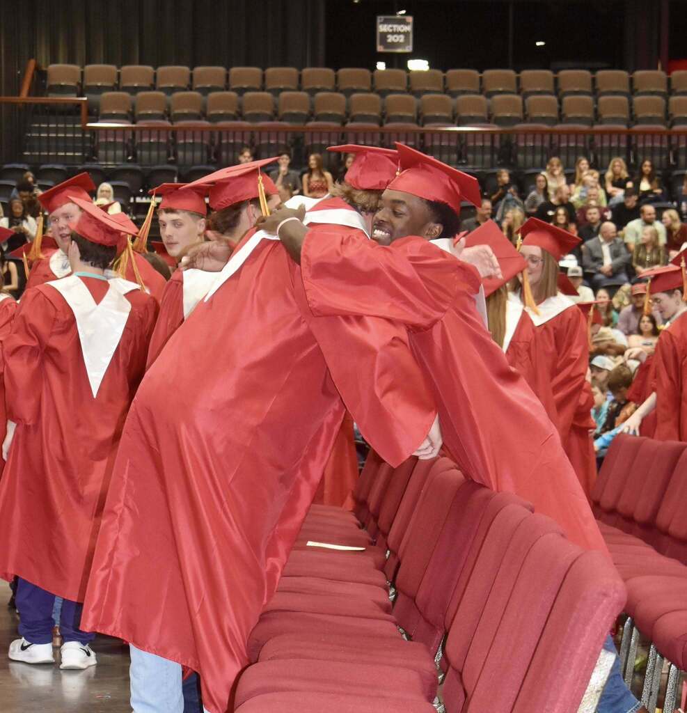 Graduating students hugging