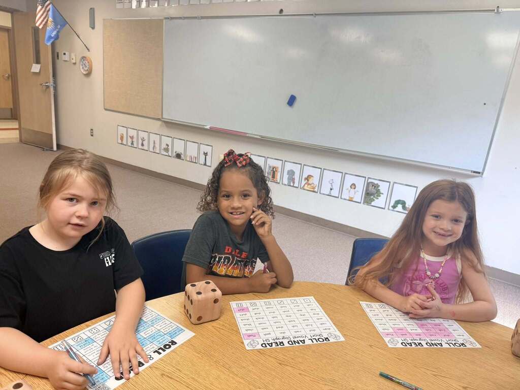A group of 3 students in a classroom