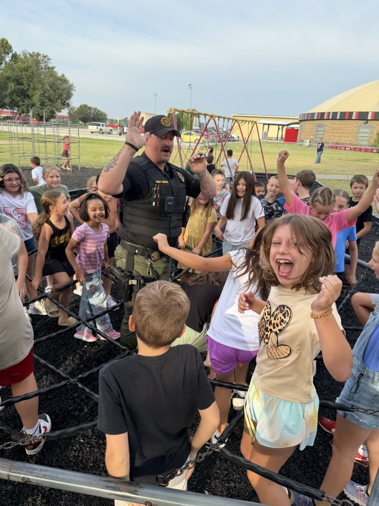 SRO playing on the playground with elementary students. 