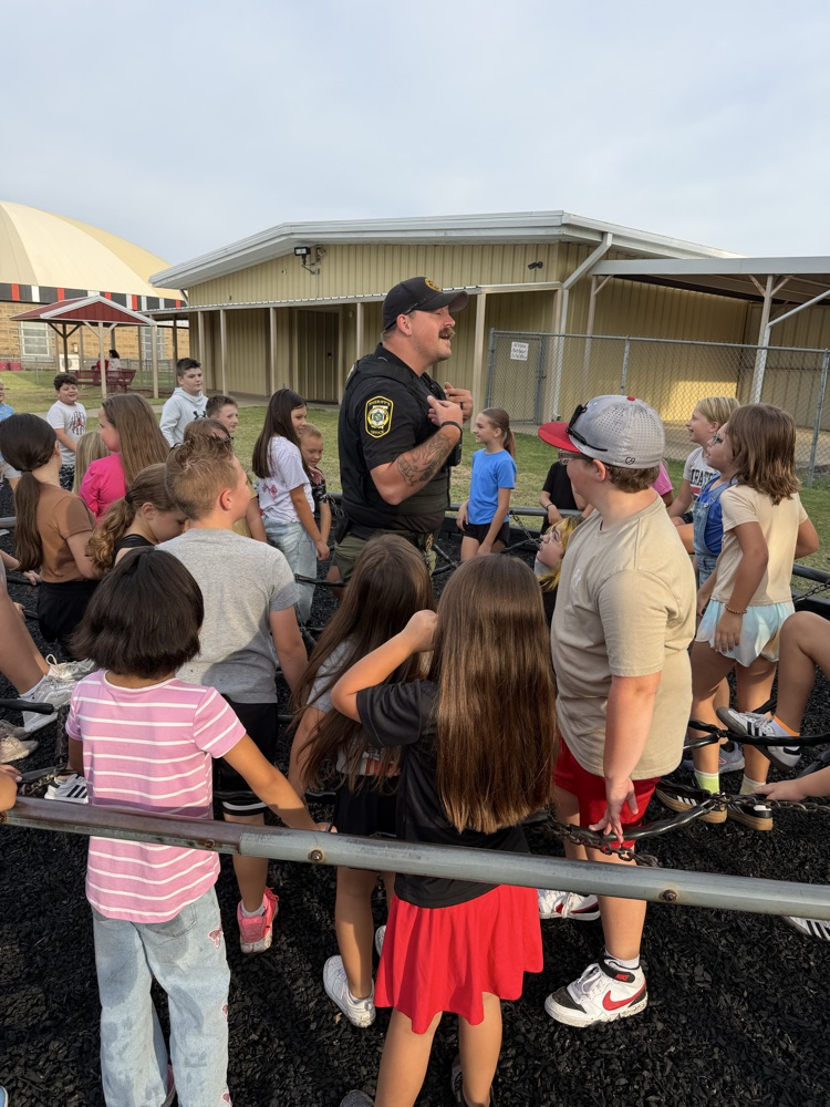 SRO playing on the playground with elementary students. 