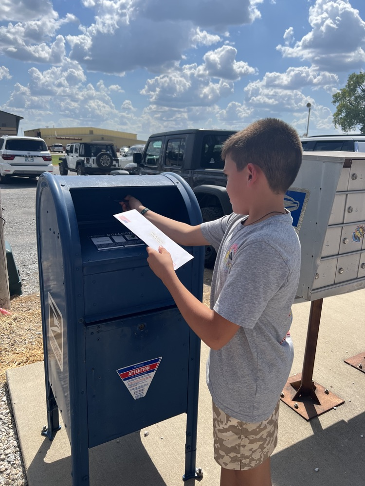 student mailing a letter