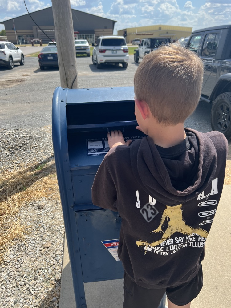 student mailing a letter