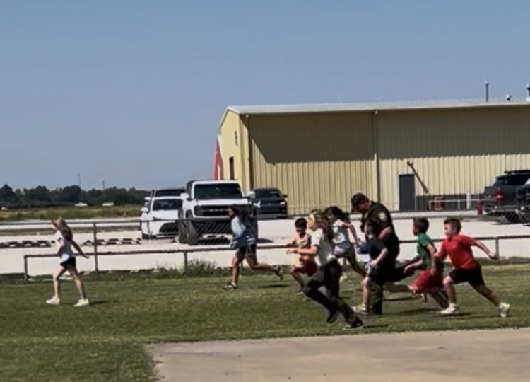 SRO running at recess with students