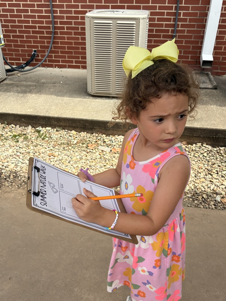 student writing outside