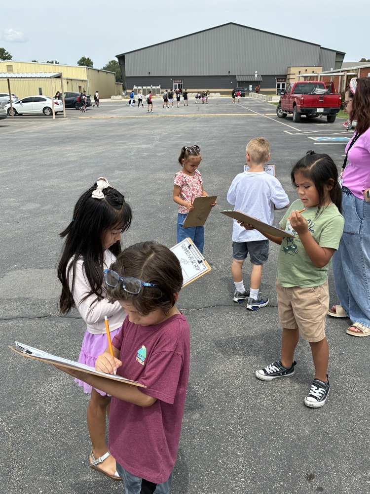 students outside writing