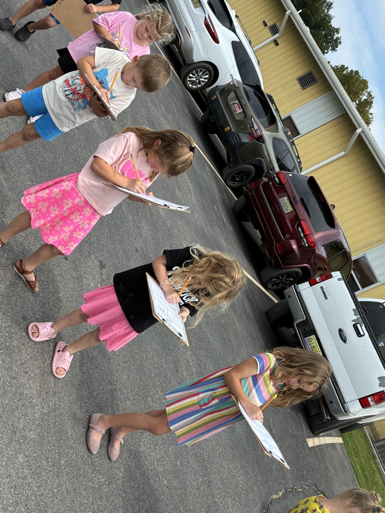students outside with clipboards