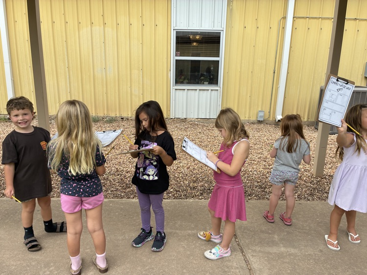 Students outside with clipboards