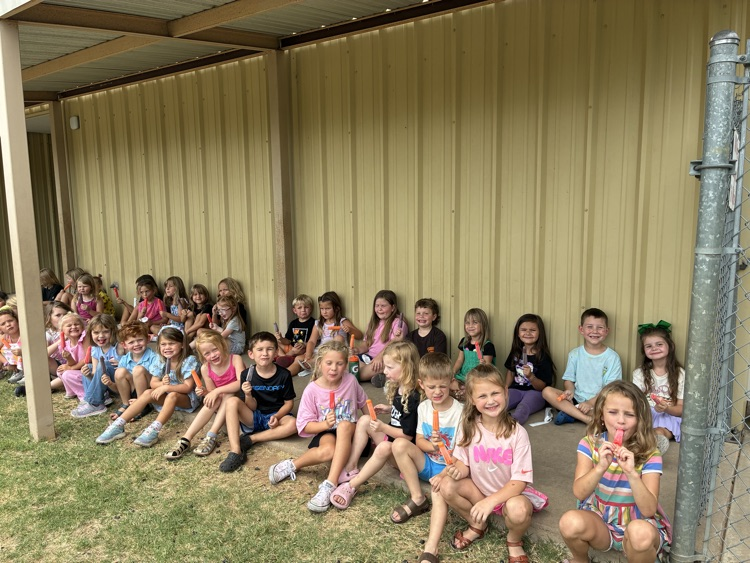 Students eating popsicles outside