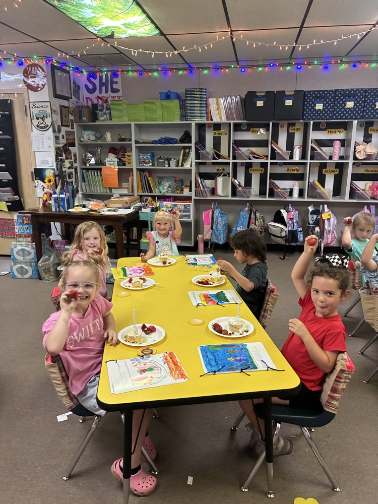 students stacking with books beside them