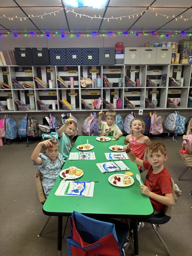 students snacking with books beside them