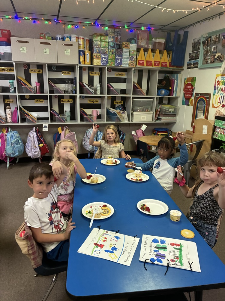 students snacking with books beside them