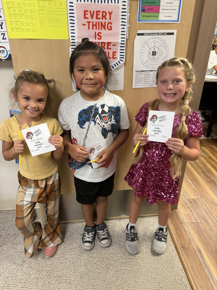 three students holding a pirate pride award