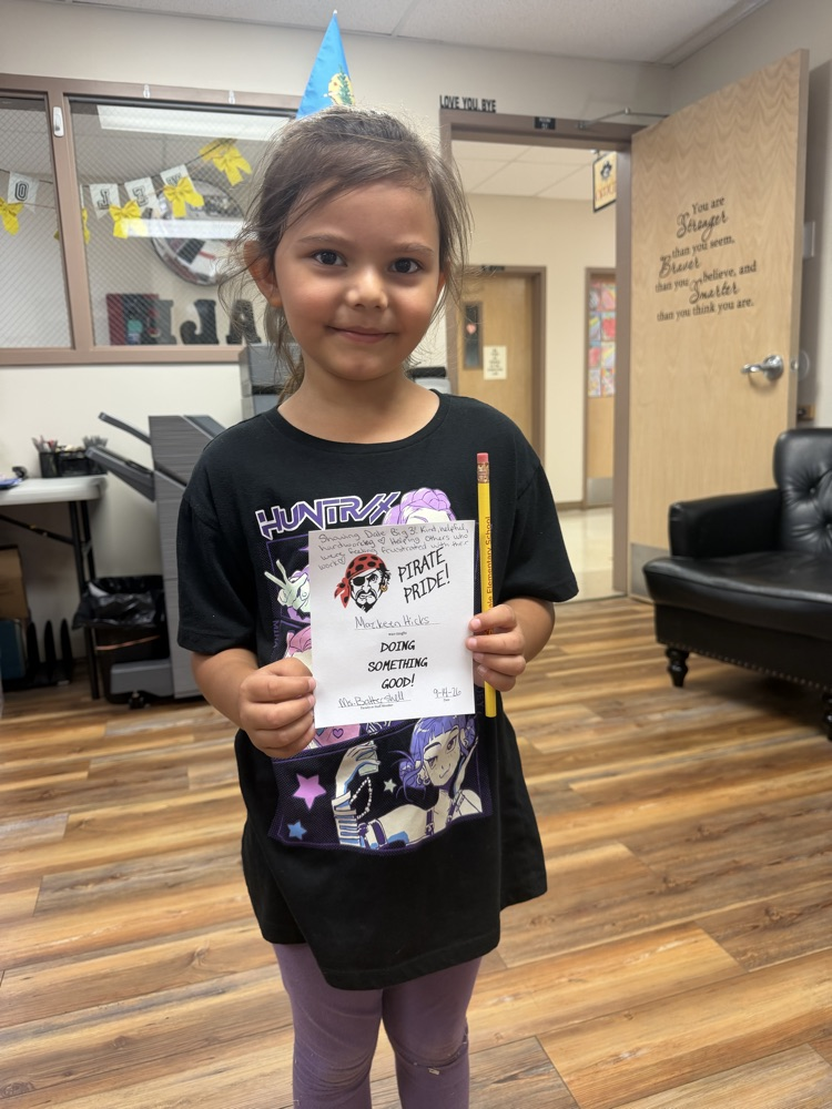 Student holding a pirate pride award