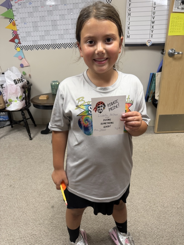 Student holding a pirate pride award