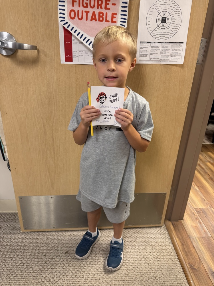 Student holding a pirate pride award