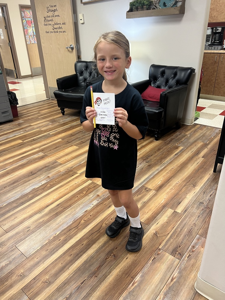 Student holding a pirate pride award
