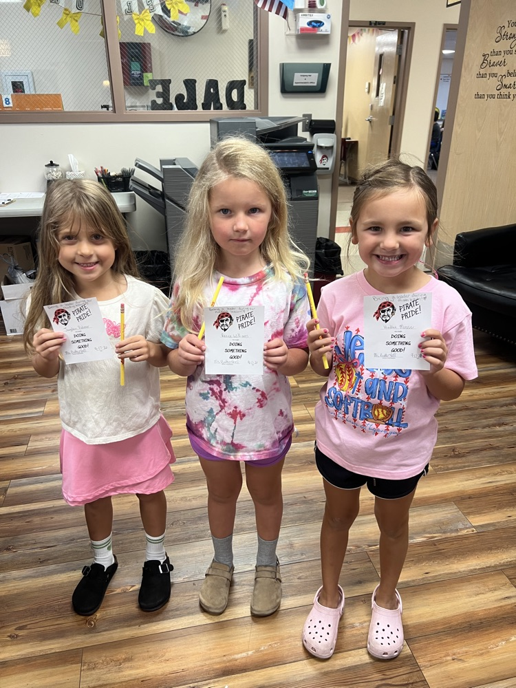 Students holding pirate pride awards