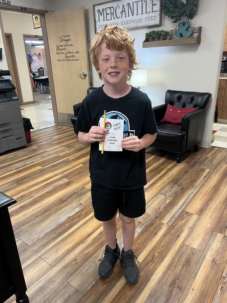 Student holding a pirate pride award