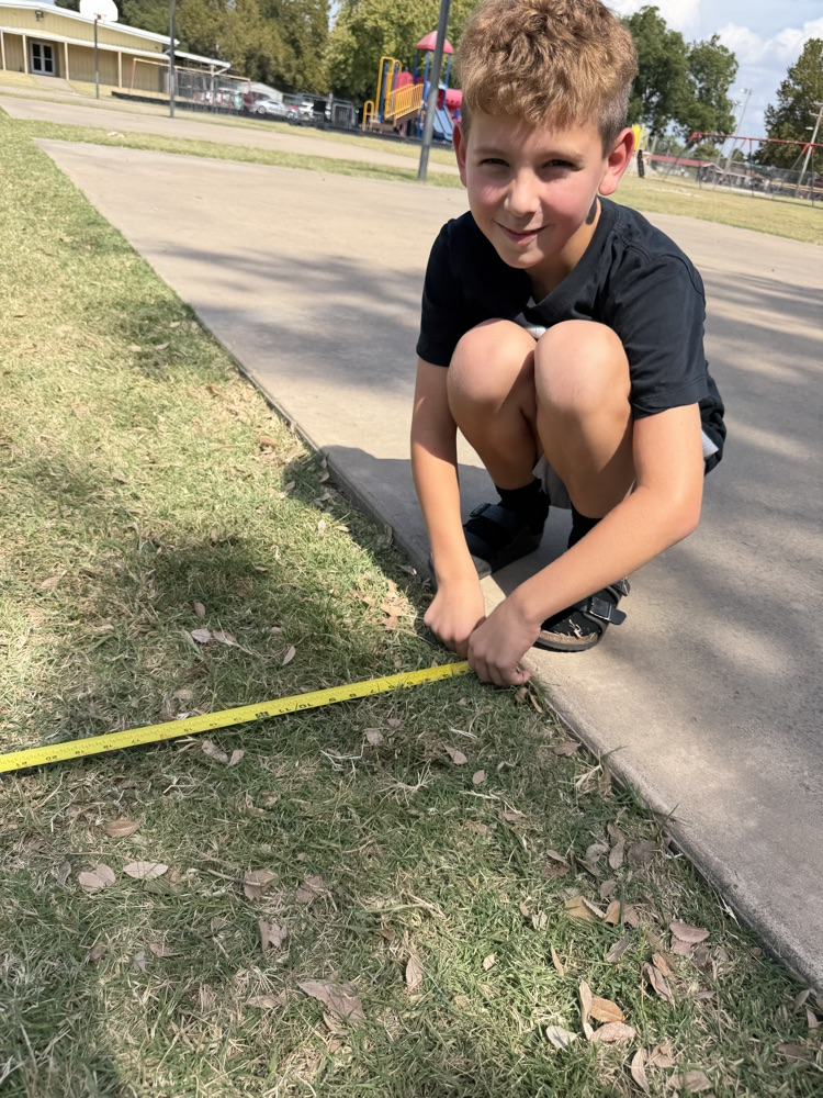 A student using a tape measure