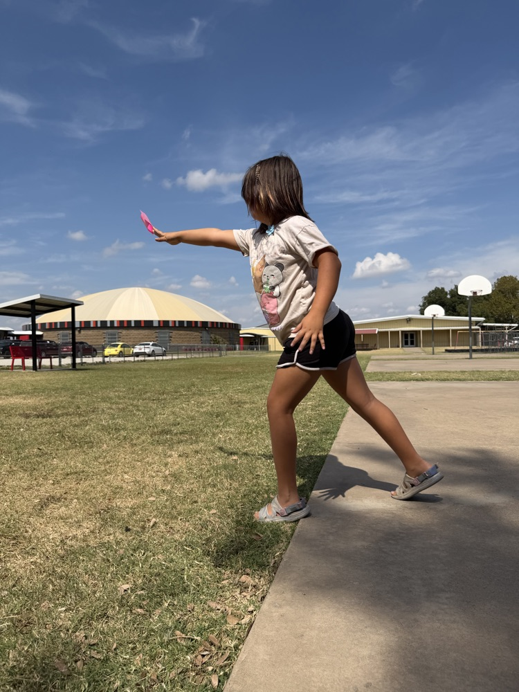 A student flying a paper airplane