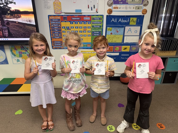 kindergarten students holding up pirate pride awards