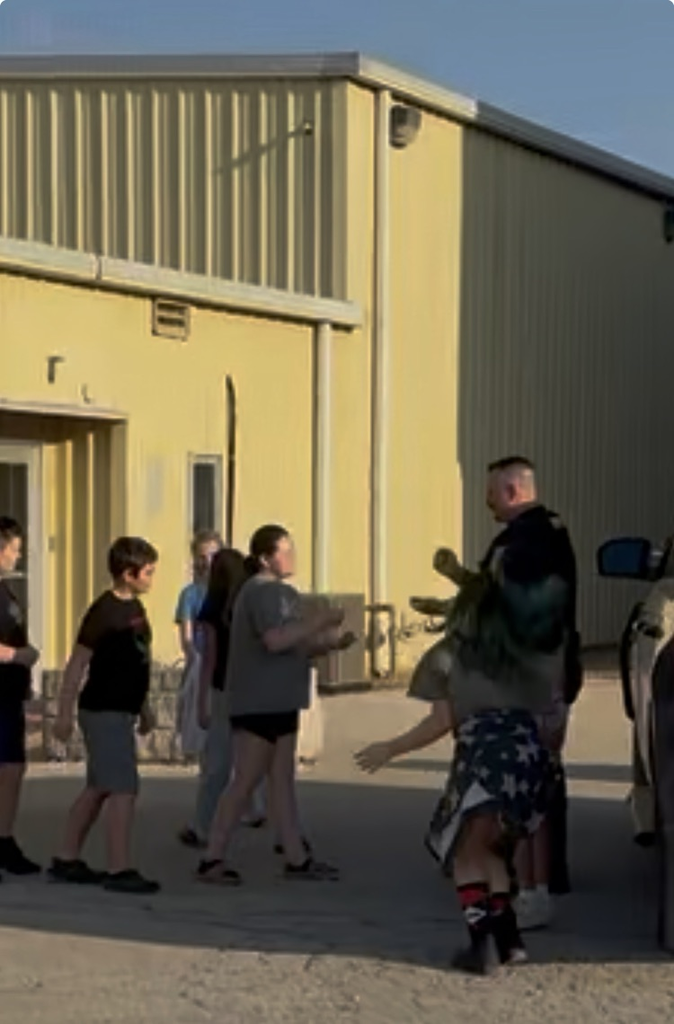 Students and SRO playing rock-paper-scissors.
