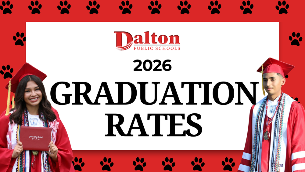 Graphic announcing Dalton Public Schools’ 2026 graduation rates. The DPS logo appears above large text reading “2026 Graduation Rates.” Two graduates in red caps and gowns are pictured on either side, surrounded by a red border with black paw prints.