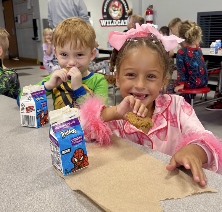 Students enjoying cookies and milk.