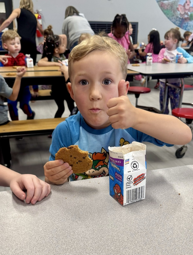 Students enjoying cookies and milk.