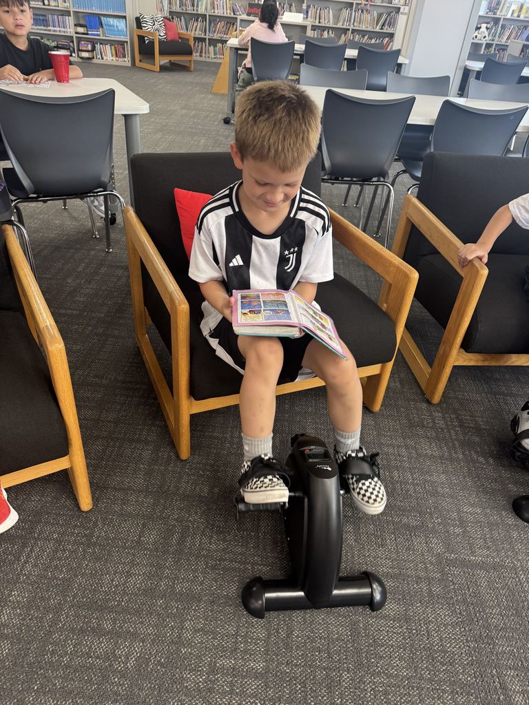 student reading while pedaling