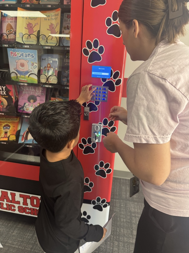 students at book vending machine