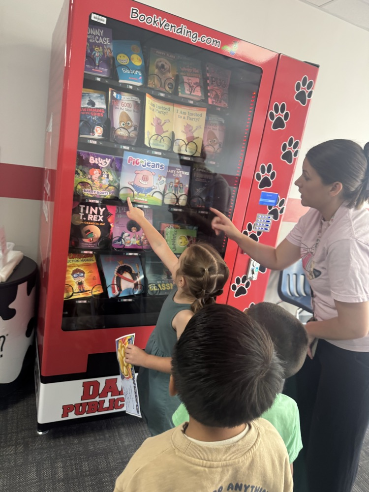 students at book vending machine