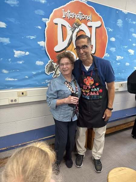 Mr. D and friend in front of Dot Day sign