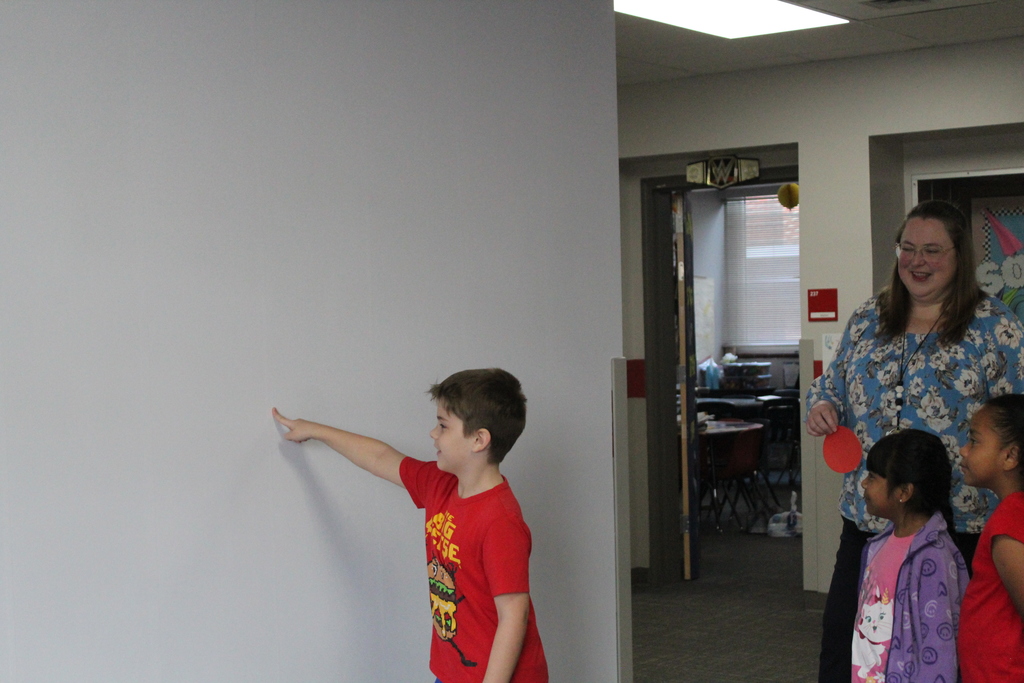 Students placing dots on wall 