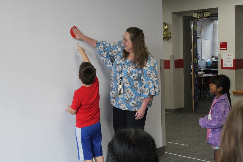 Students placing dots on wall 