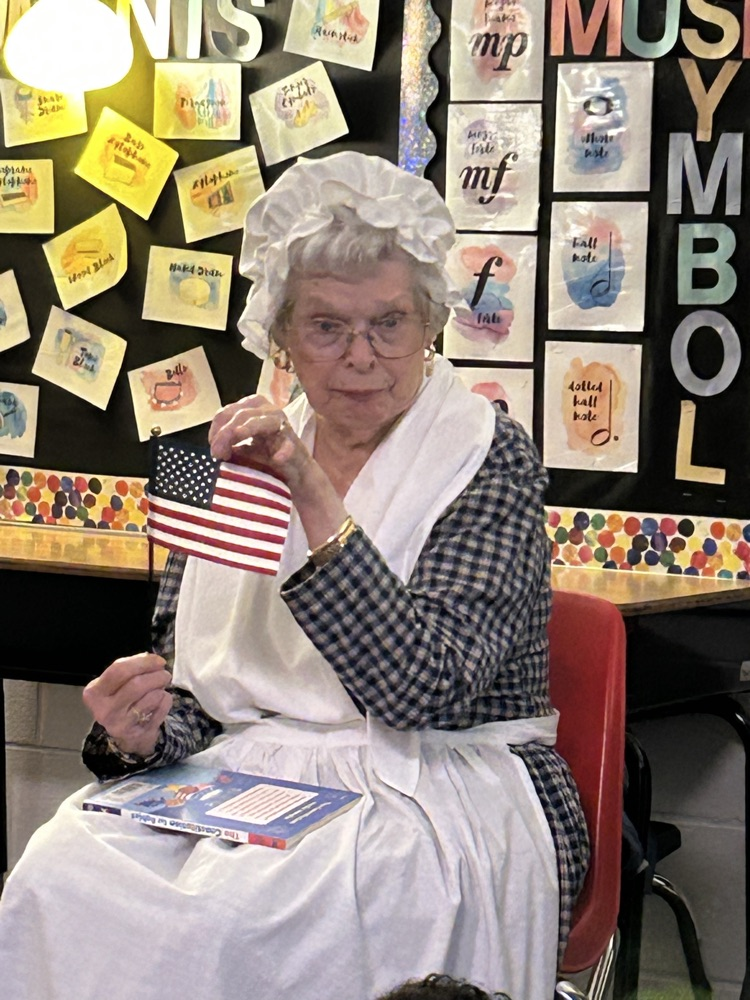 Mrs. Meek holding an American flag 