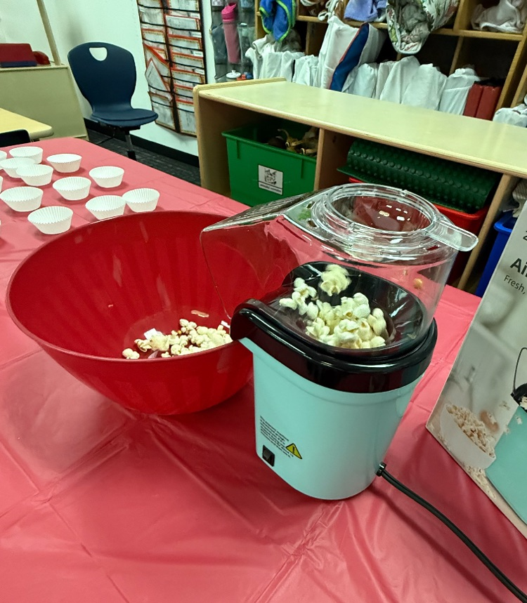 A picture of pop corn popping on the air  popper