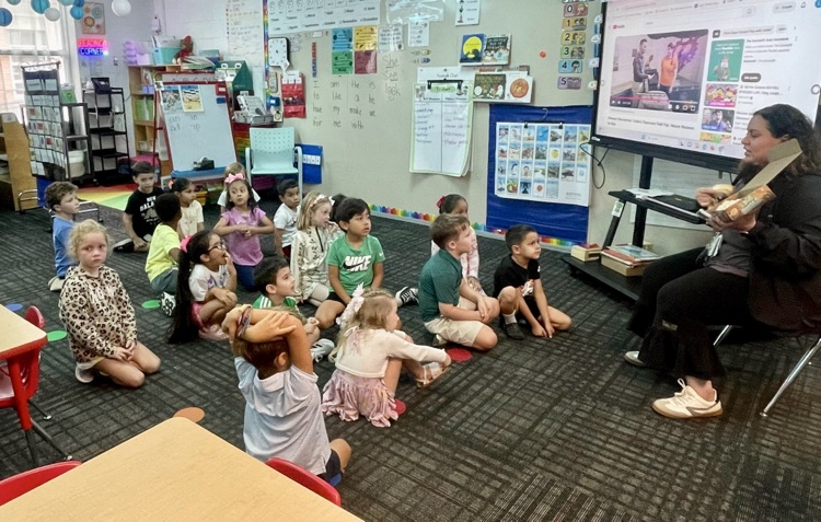 Students listening to Ms. Diaz