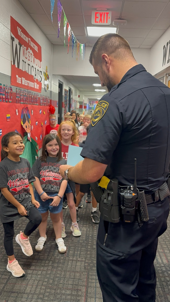 students presented the book to Officer Warren 