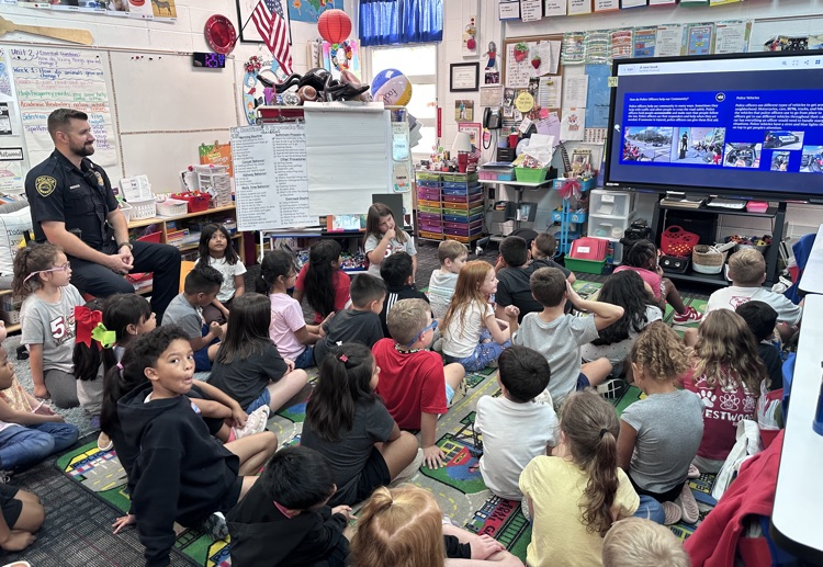 Students watching the presentation with Officer Warren 