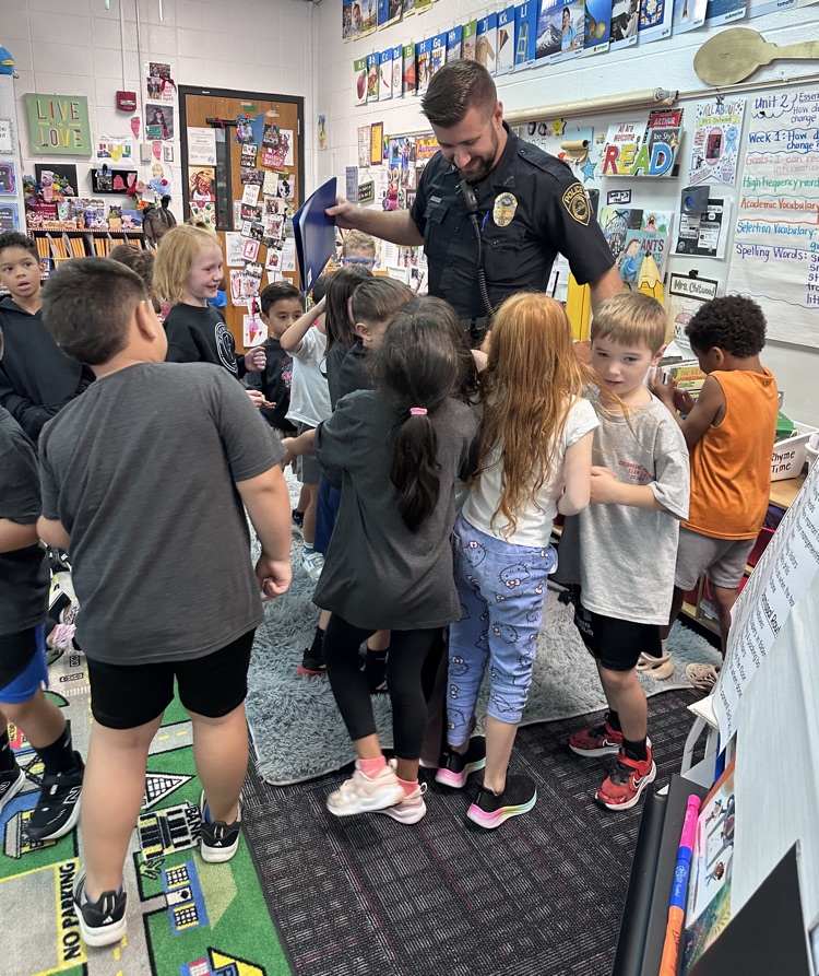 Students hugging Officer Warren 
