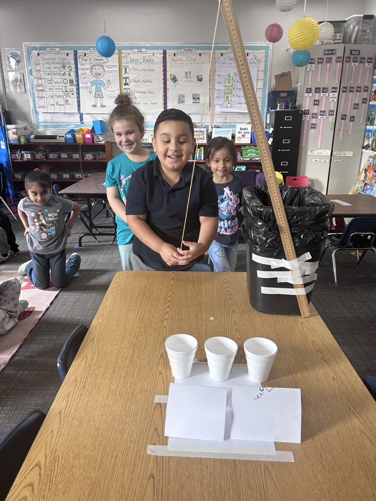 kindergartners working on science experiment 